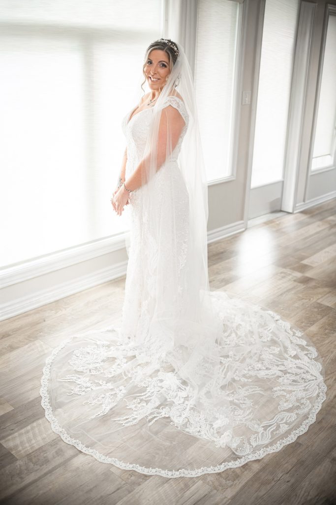 bride with wedding dress trail posed in Chatham