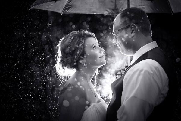 wedding day photo standing in the rain