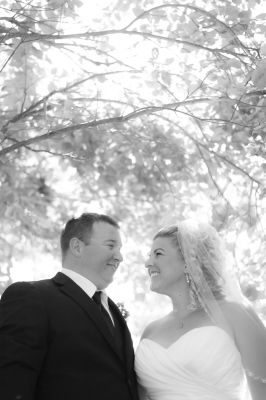 bride and groom standing under a tree in Chatham