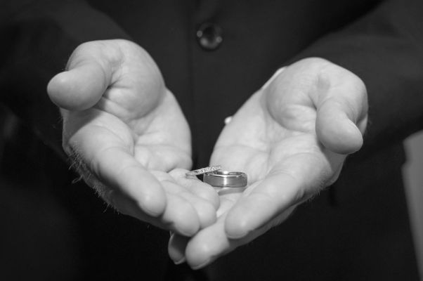wedding rings in grooms hand at a church in Chatham