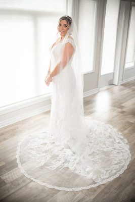 bride with wedding dress trail posed in Chatham