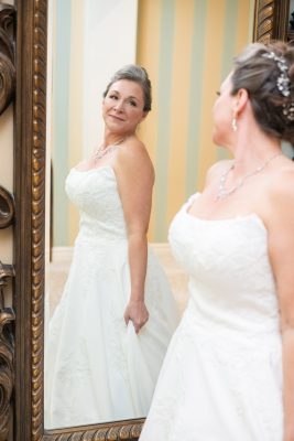 Bride admiring her dress at a hotel in Chatham