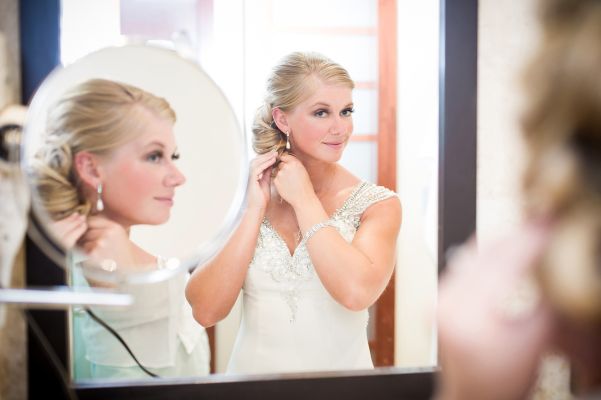 stunning bride looking in the mirror on her wedding day