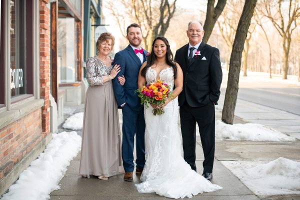 bride and groom and their family members on a snowy day in downtown Chatham Ontario