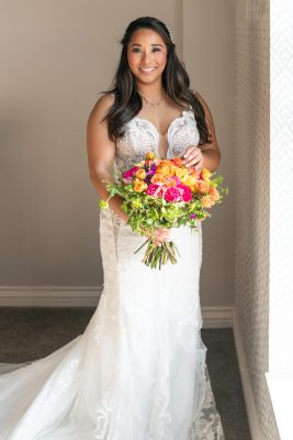 photo of bride naturally lit by a window at a hotel in Chatham on her wedding day