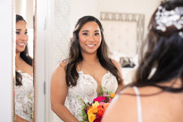 bride looking into the mirror, creative photography playing with multiple mirrors (advanced wedding photography)