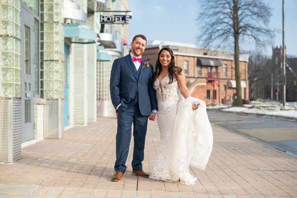 groom and bride holding up her wedding dress before their chatham wedding
